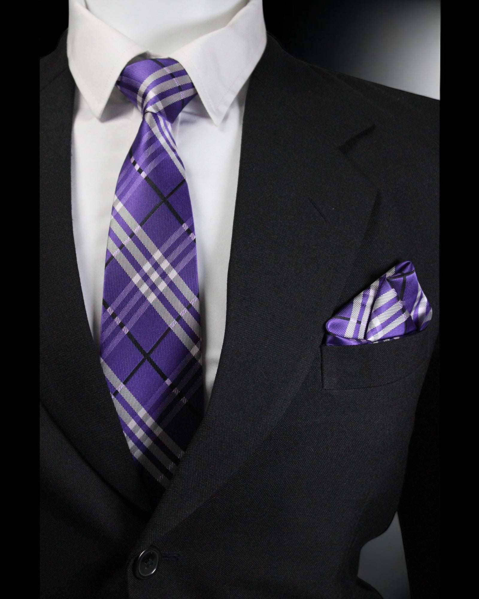 Black suit with a white shirt, purple plaid tie, and matching pocket square Tie Benon