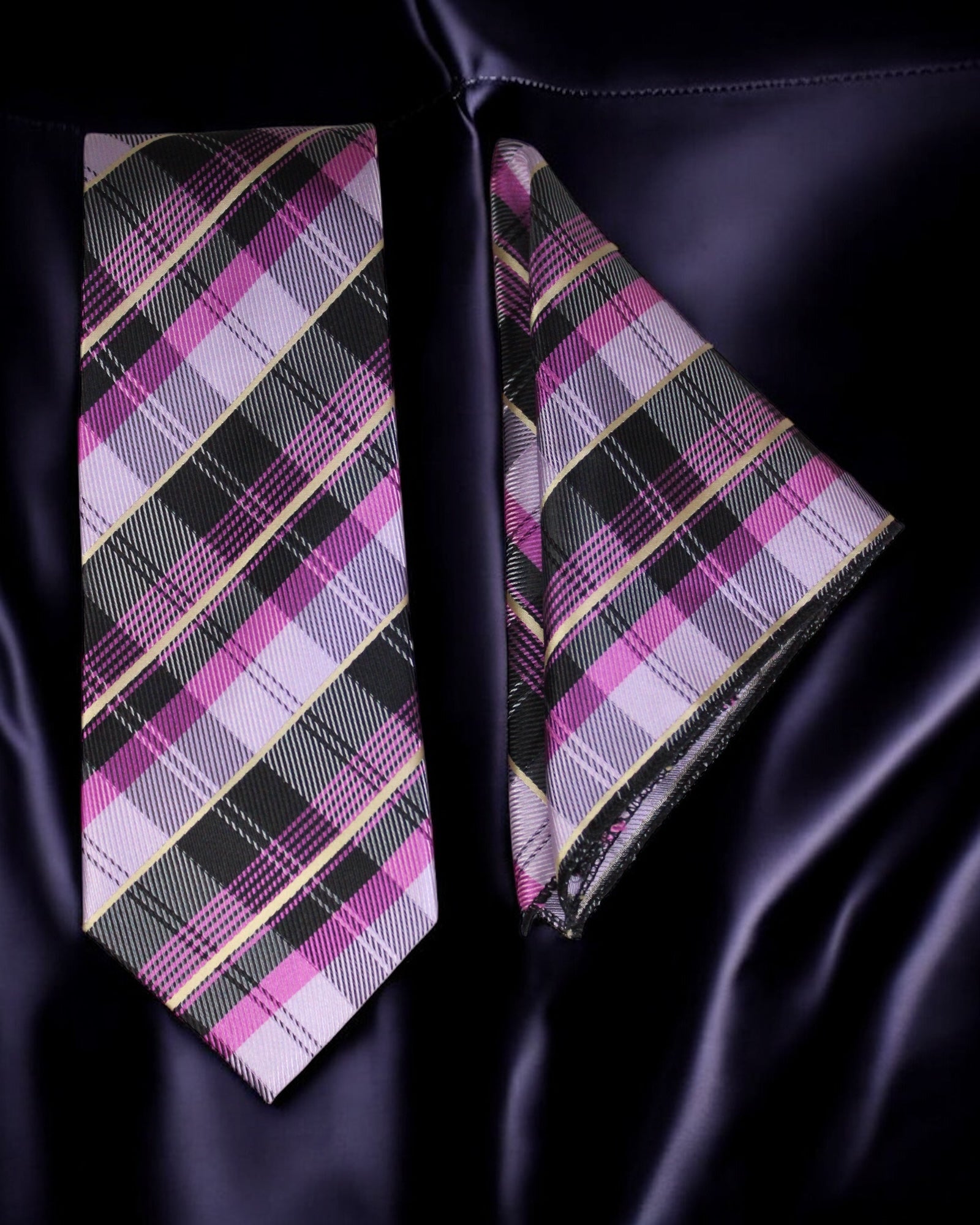 Plaid tie and matching pocket square on a dark fabric background Tie Benon