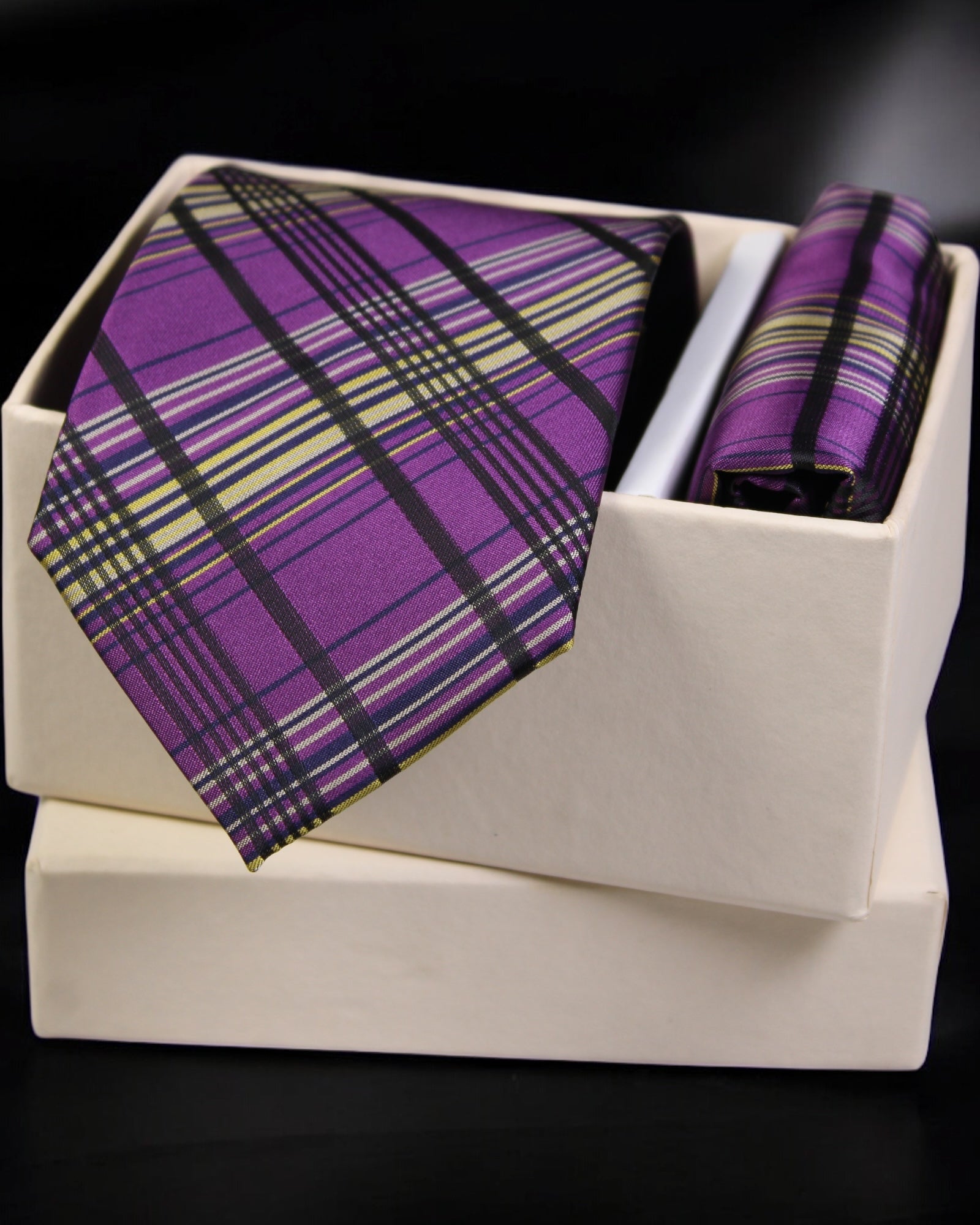 Purple plaid tie and matching pocket square in a white box on a black background