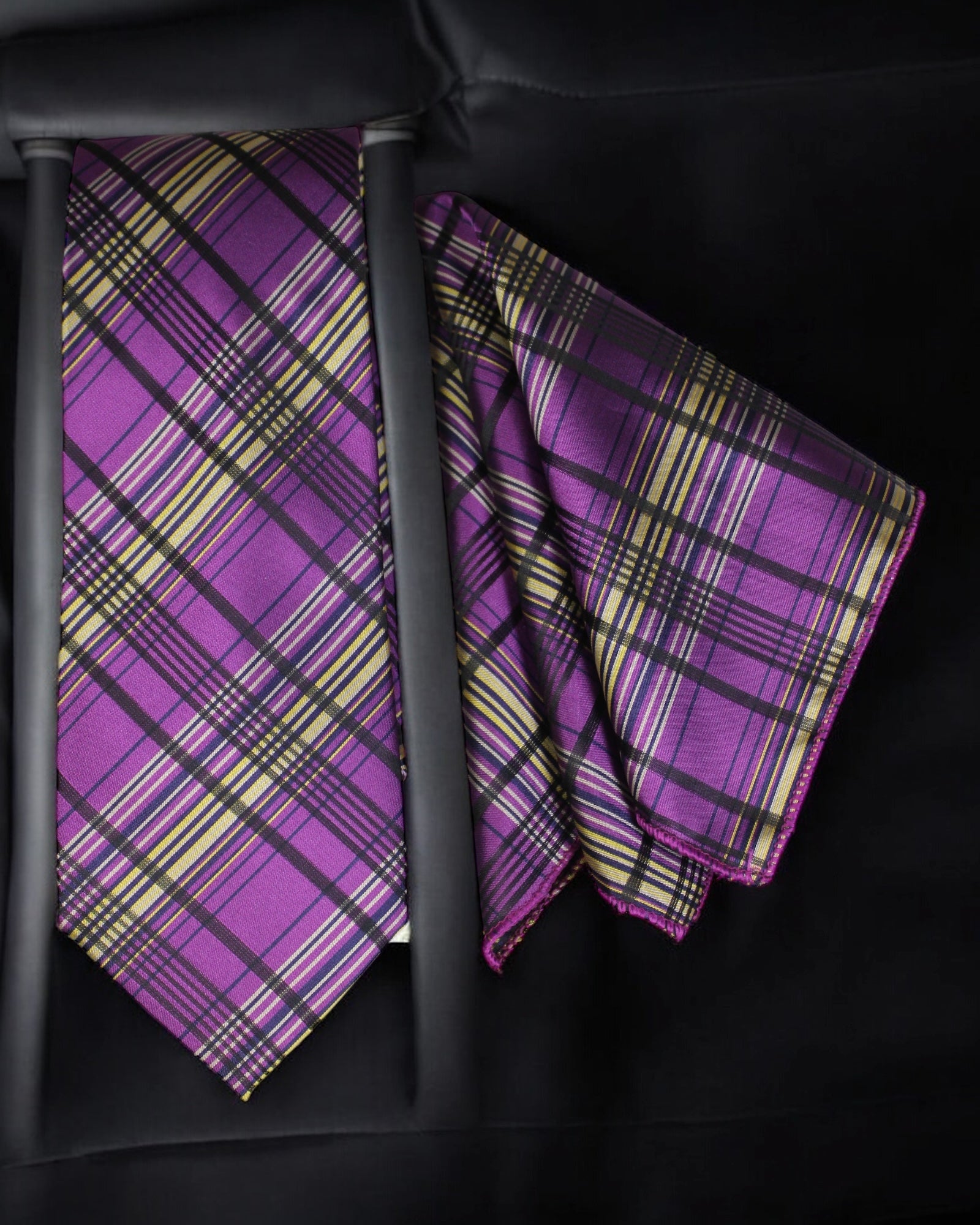 Purple plaid tie and matching pocket square on a black background