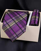 Purple plaid tie and pocket square set in a white box on a dark background