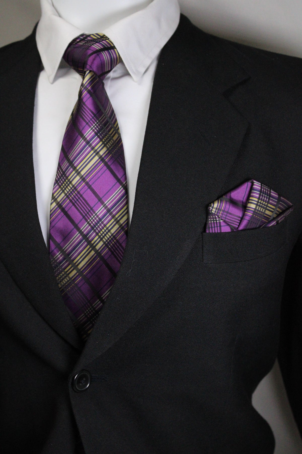 Purple plaid tie on a black suit with a white shirt