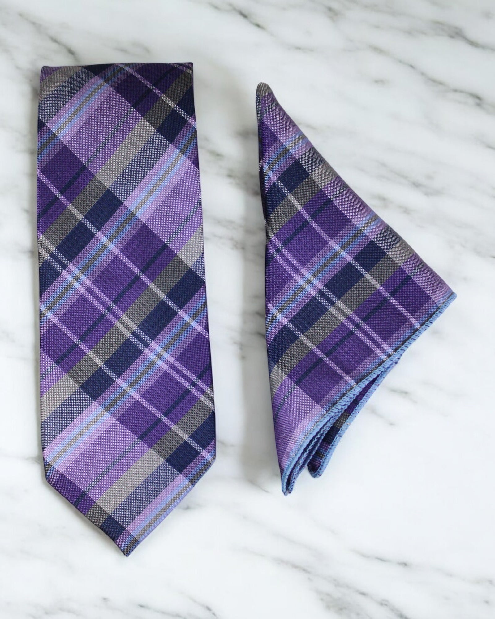 Purple and gray plaid tie and pocket square on a marble surface Tie Benon