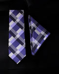 Plaid tie and pocket square set on a black background