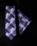 Plaid tie and pocket square set on a black background