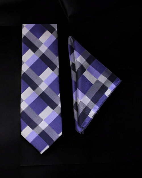 Plaid tie and pocket square set on a black background