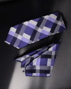 Plaid tie with purple, gray, and black pattern on a dark background