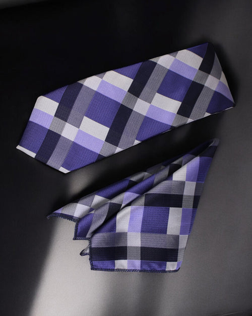 Plaid tie with purple, gray, and black pattern on a dark background