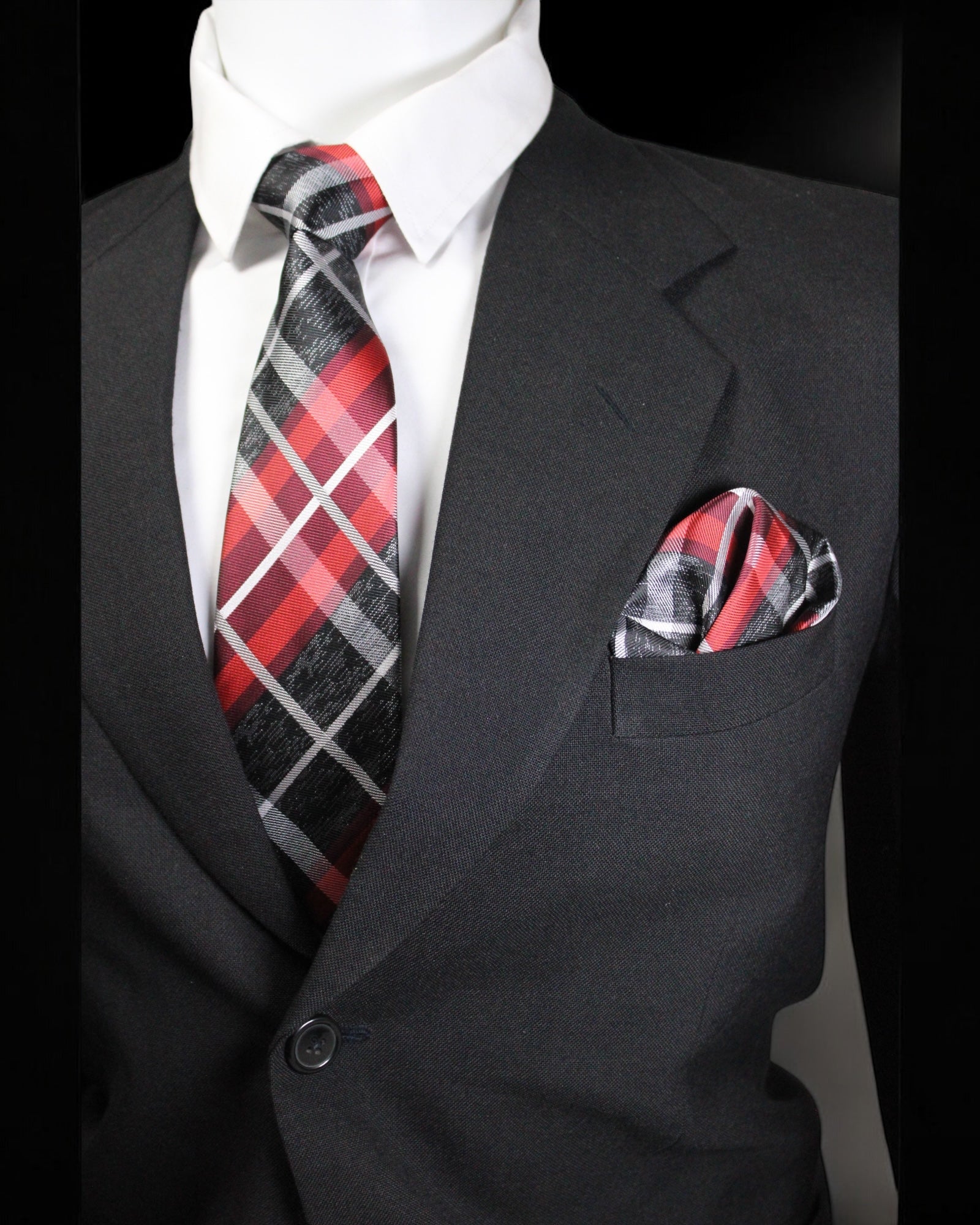Black suit with red and gray plaid tie and pocket square on a mannequin Tie Benon