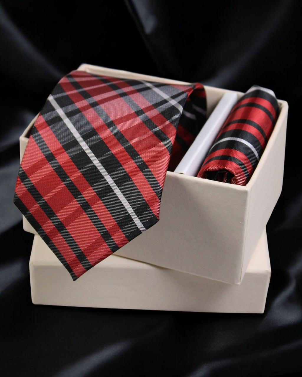 Red and black plaid tie and pocket square set in a white box on a black background Tie Benon