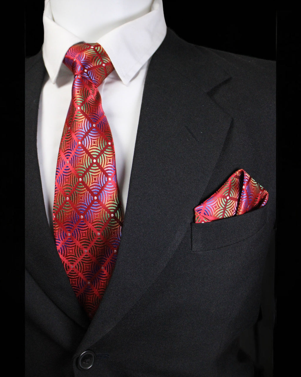 Black suit with a red patterned tie and pocket square on a black background Tie Benon