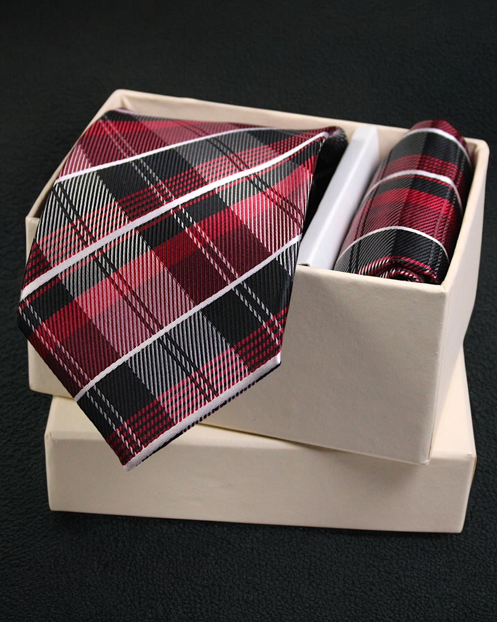 Plaid tie and pocket square set in a white box on a black background Tie Benon
