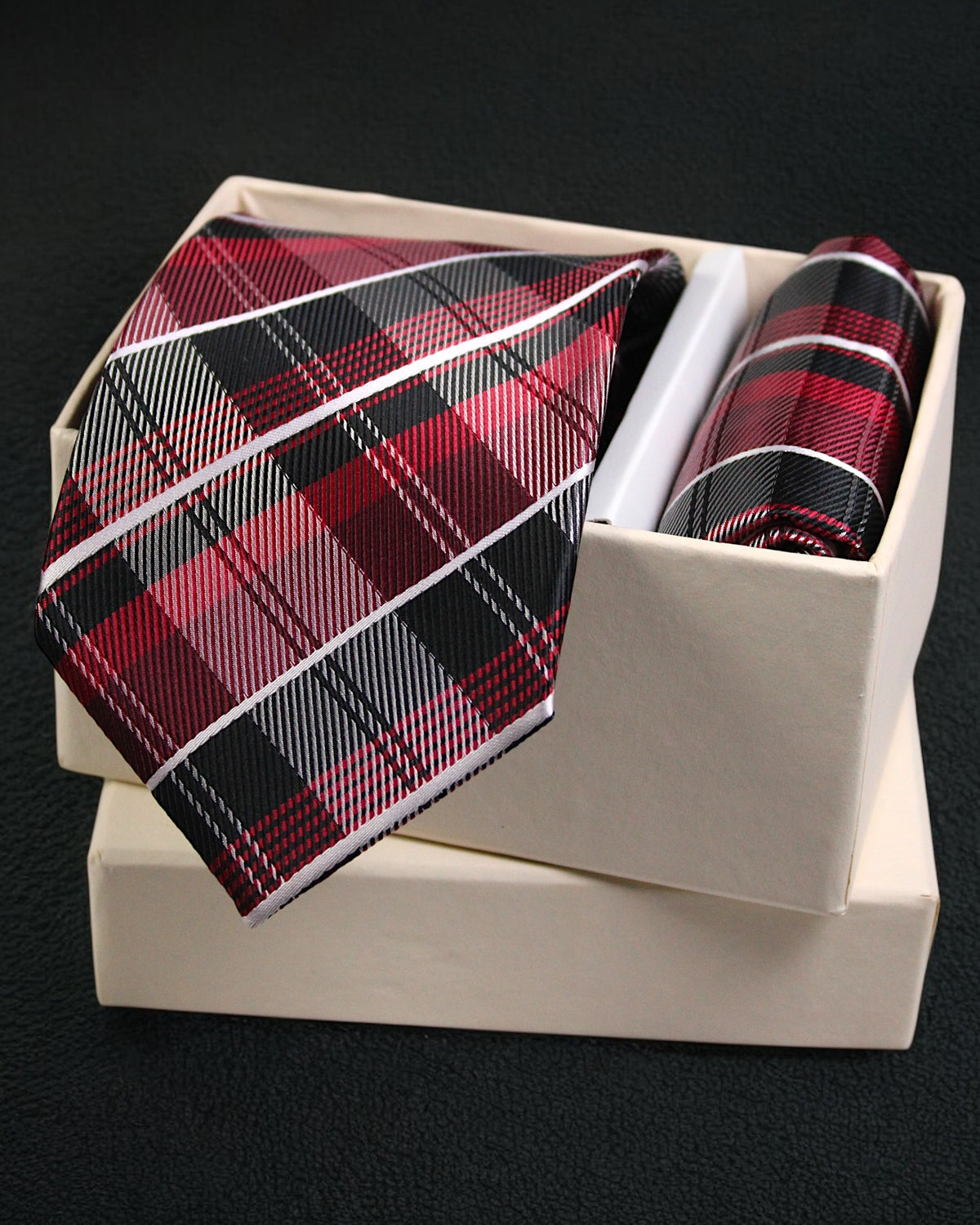 Plaid tie and pocket square set in a white box on a black background Tie Benon
