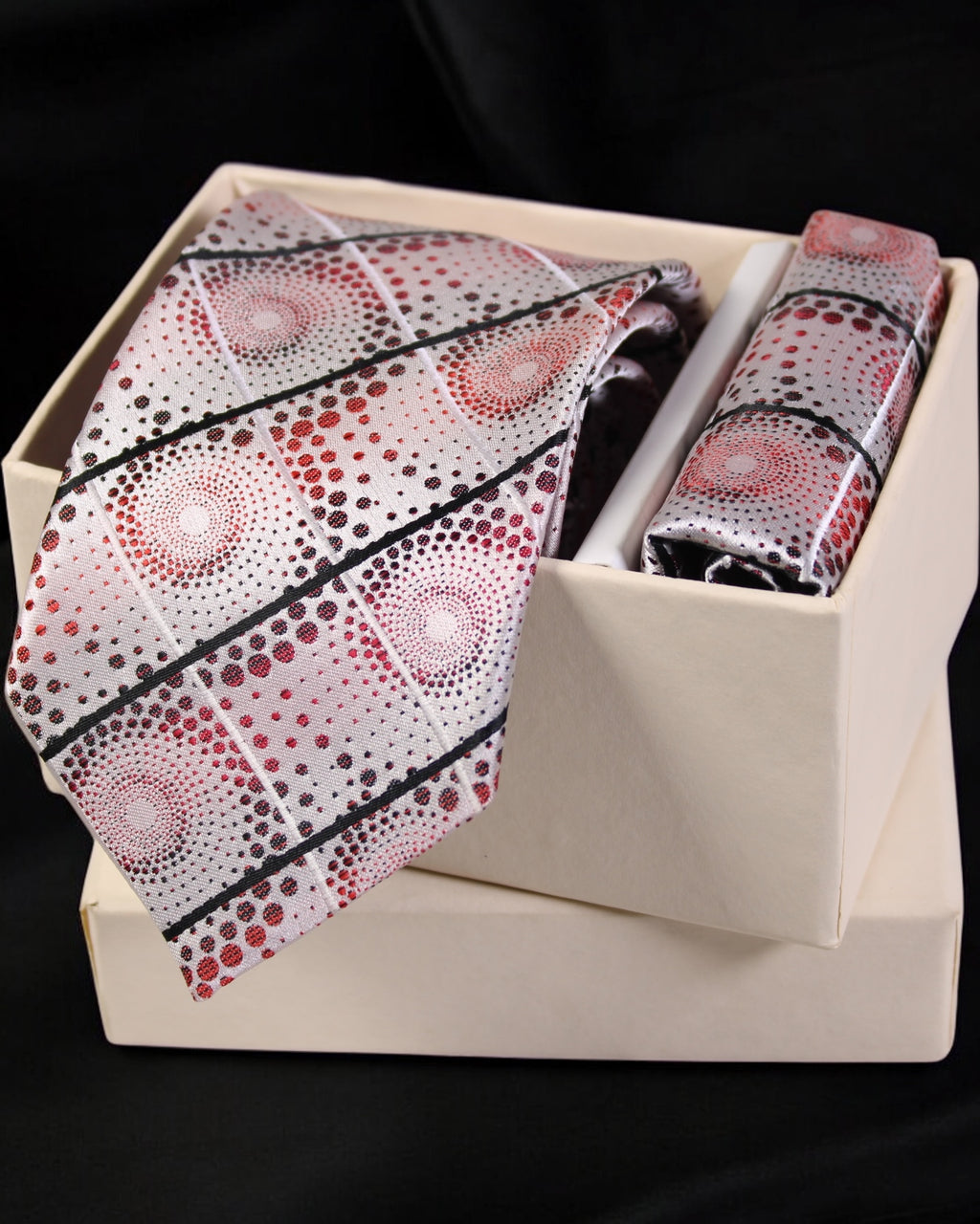 Patterned tie and handkerchief set in a box on a black background Tie Benon