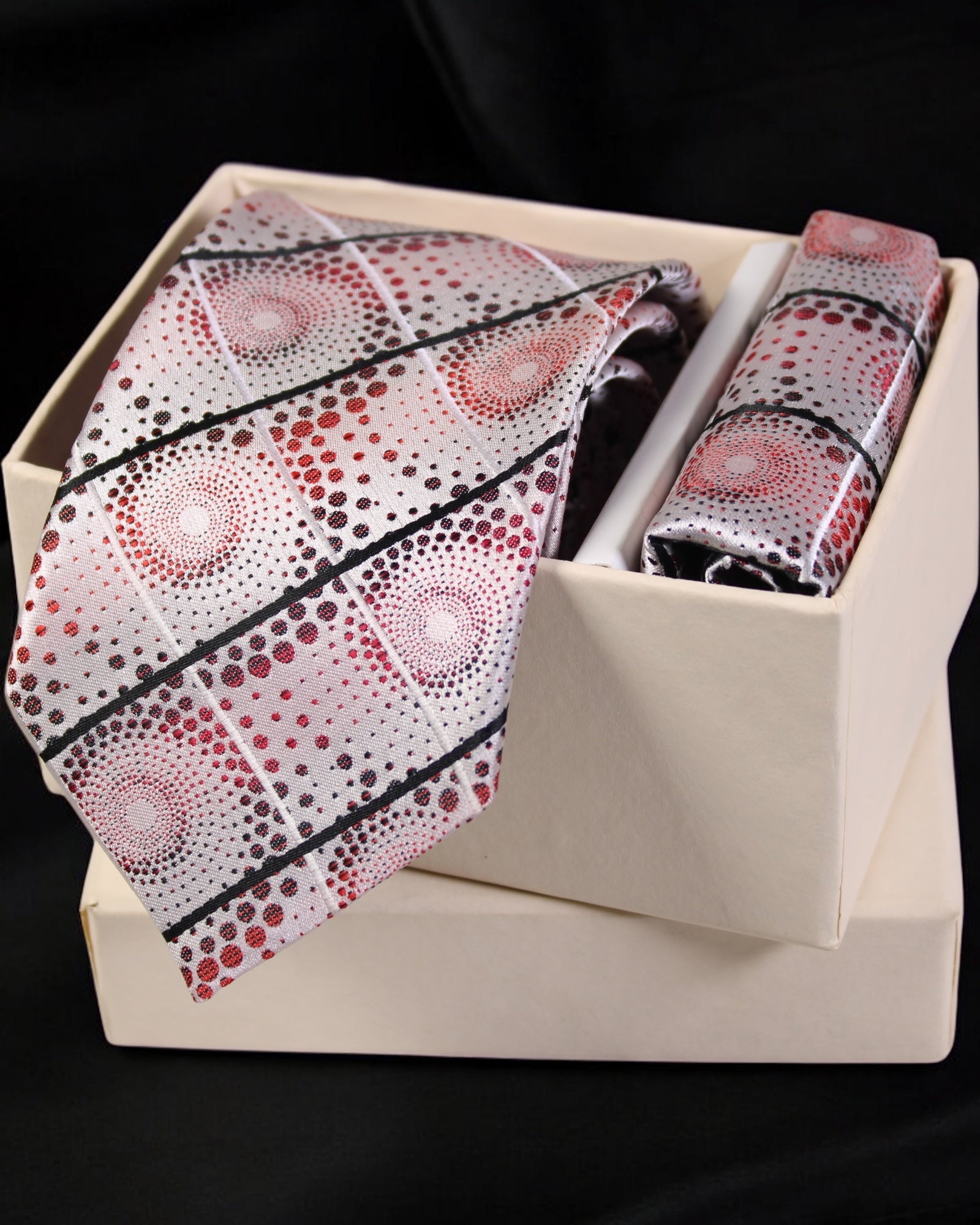 Patterned tie and handkerchief set in a box on a black background Tie Benon