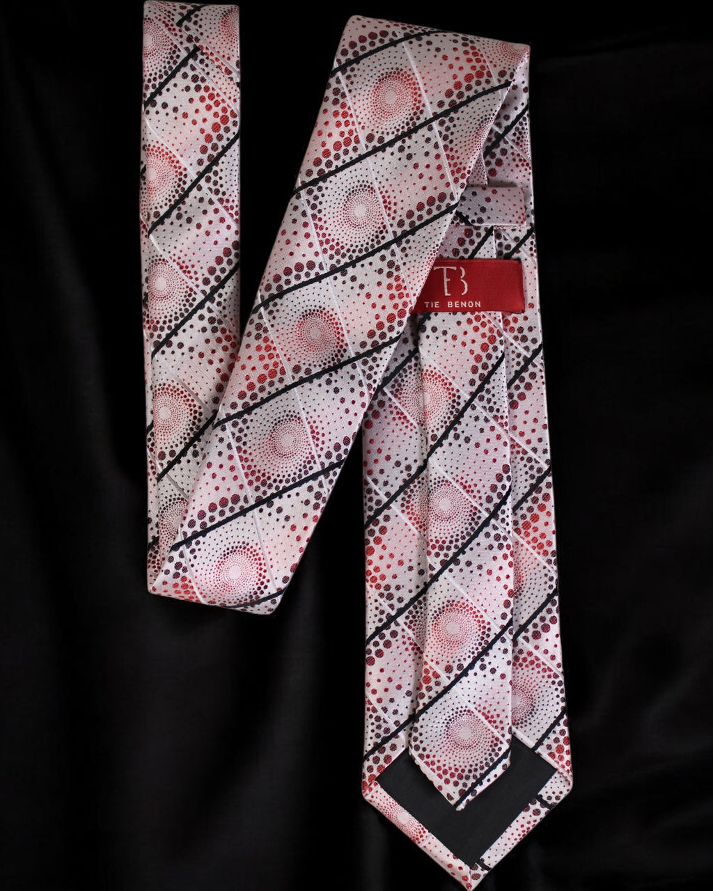 Patterned tie with a brand label on a black background Tie Benon