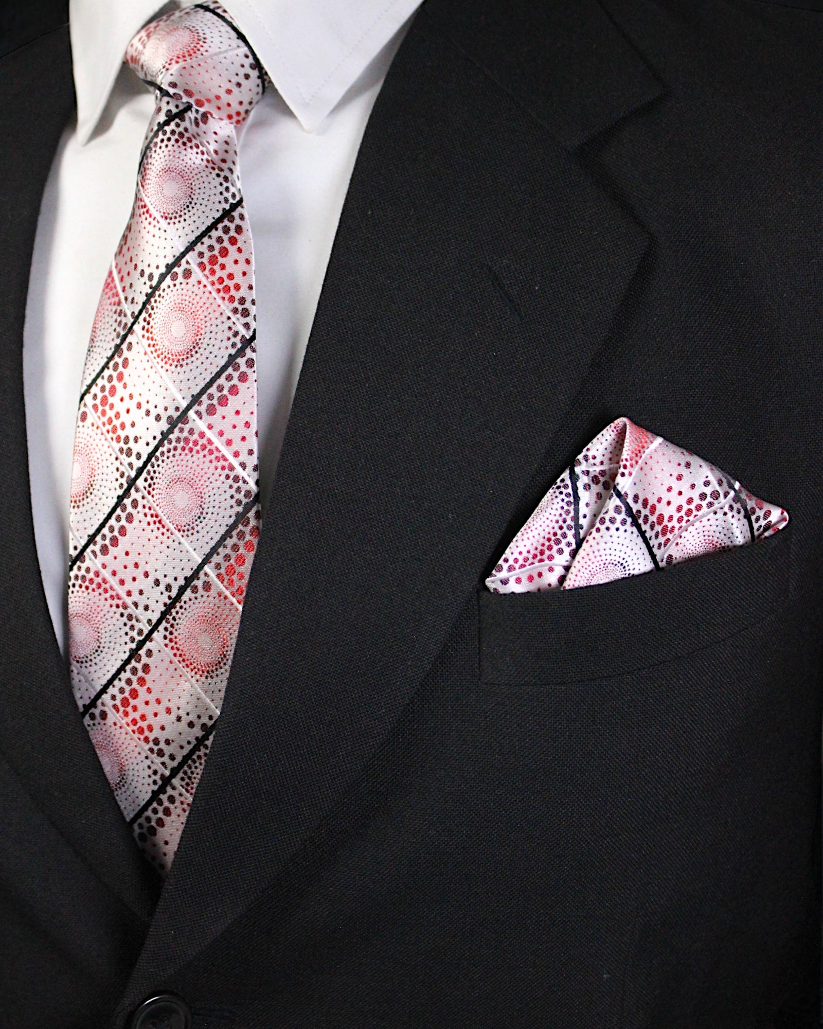 Black suit with a patterned tie and pocket square Tie Benon