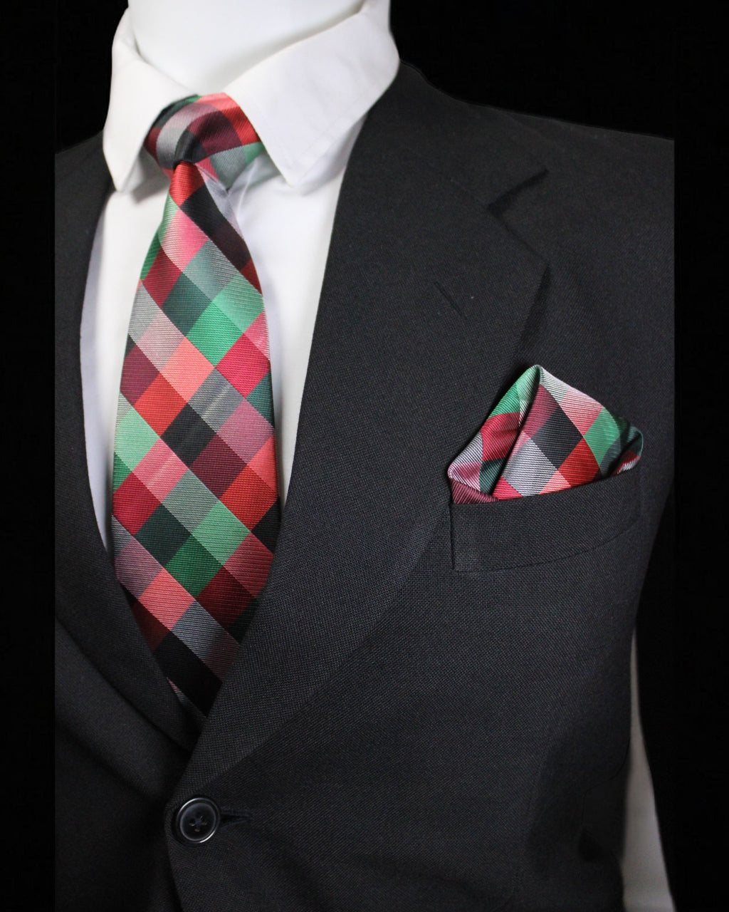 Black suit with a plaid tie and pocket square on a black background Tie Benon