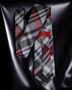 Plaid tie with a red label on a reflective black surface Tie Benon