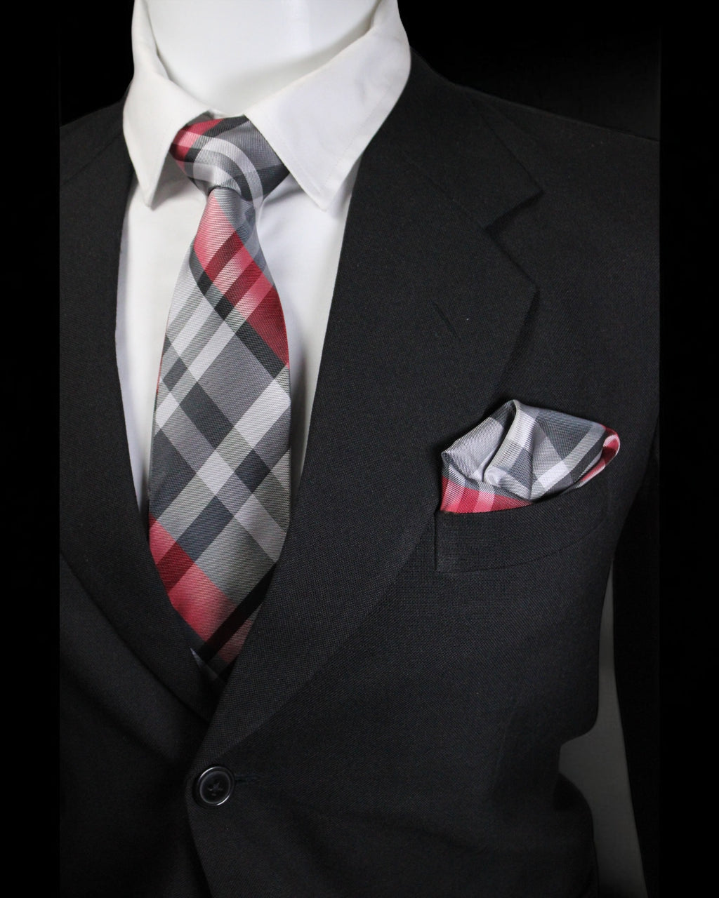 Mannequin wearing a black suit with a red and gray checkered tie and pocket square Tie Benon