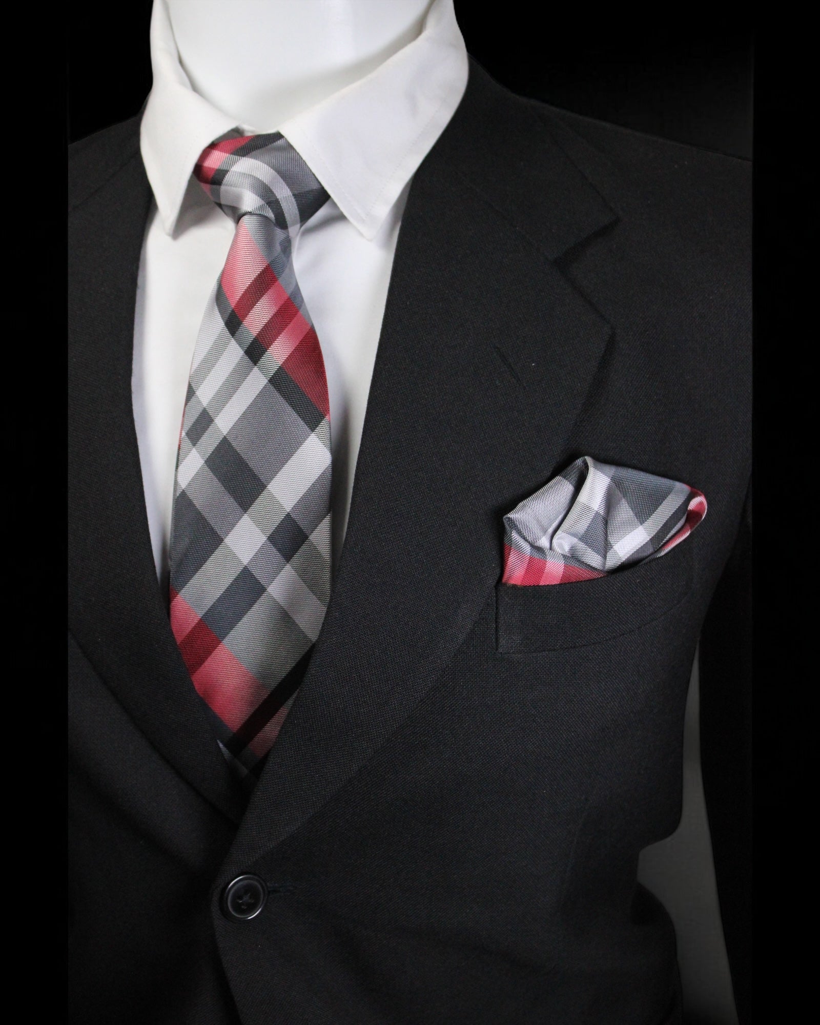 Mannequin wearing a black suit with a red and gray checkered tie and pocket square Tie Benon