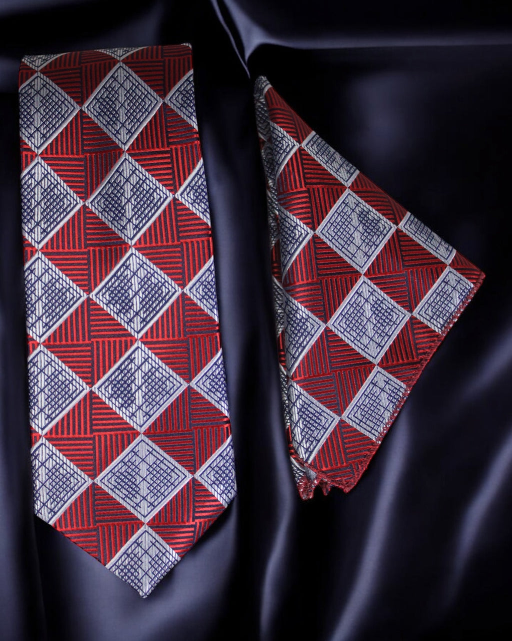 Red and blue patterned tie and pocket square on a dark fabric background Tie Benon