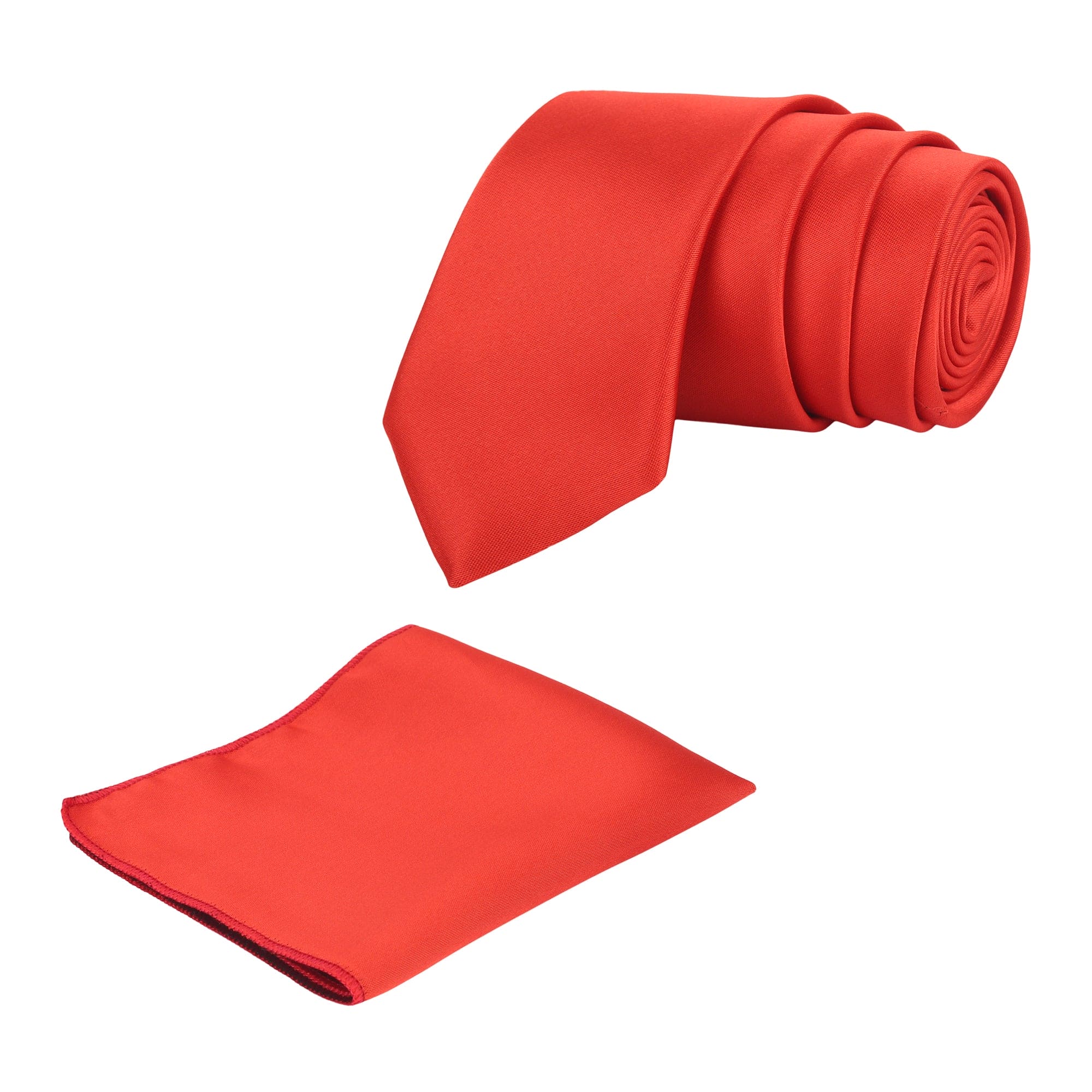 A rolled-up red solid necktie with a matching pocket square, both made of microsilk.