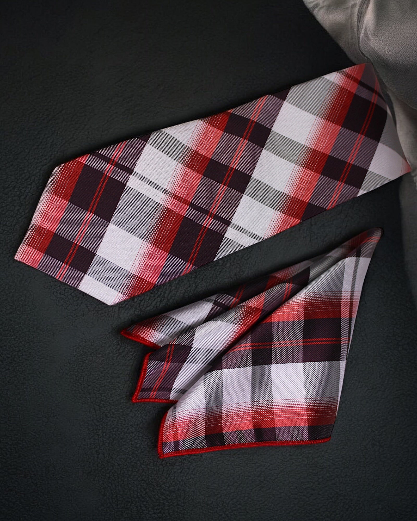 Plaid tie and pocket square set on a dark surface Tie benon