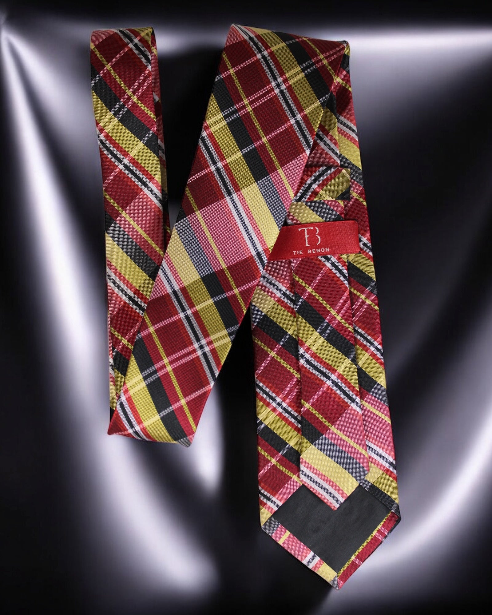 Plaid tie with a brand label on a reflective surface Tie Benon