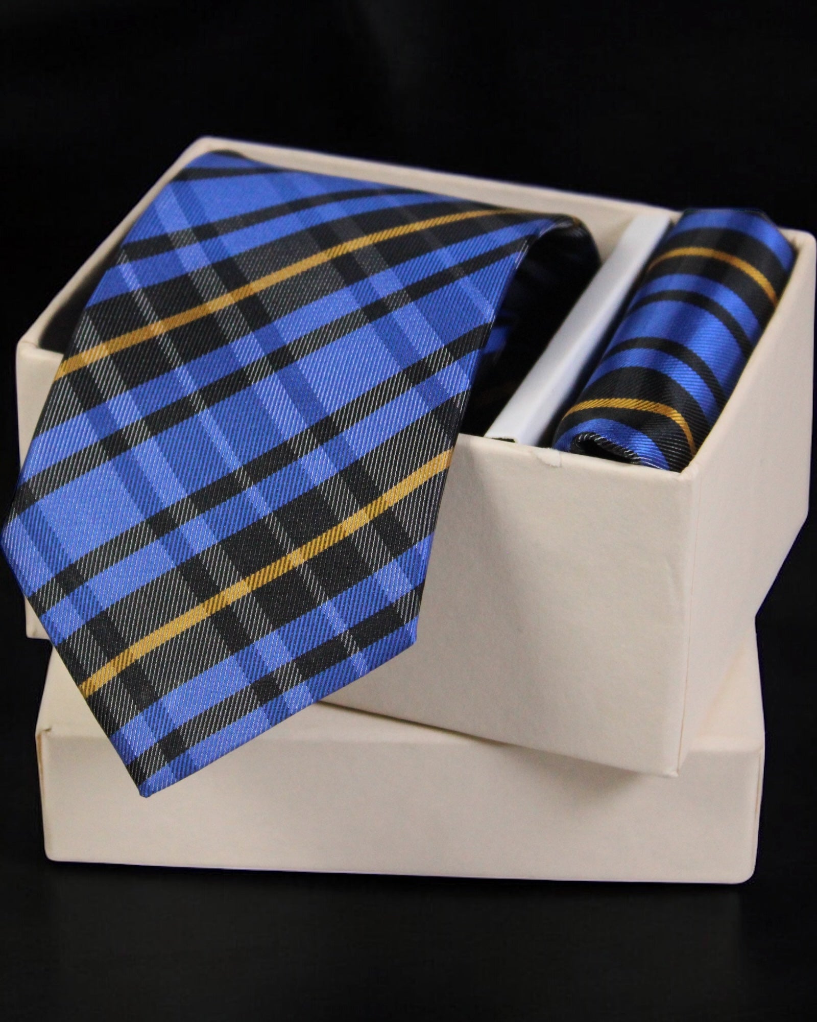 Blue plaid tie and matching pocket square in a white box on a black background Tie Benon