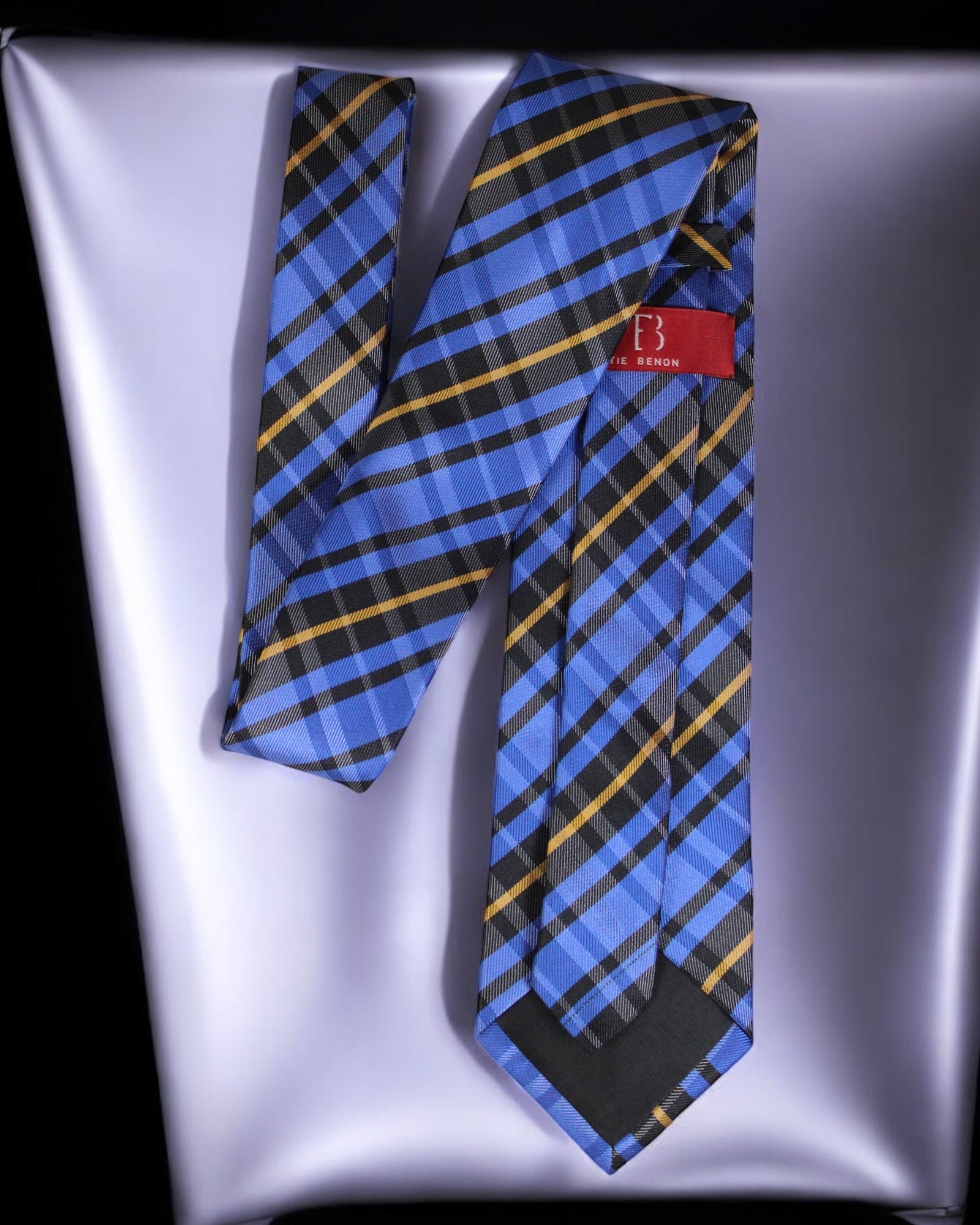 Blue plaid tie with a red label on a reflective surface Tie Benon