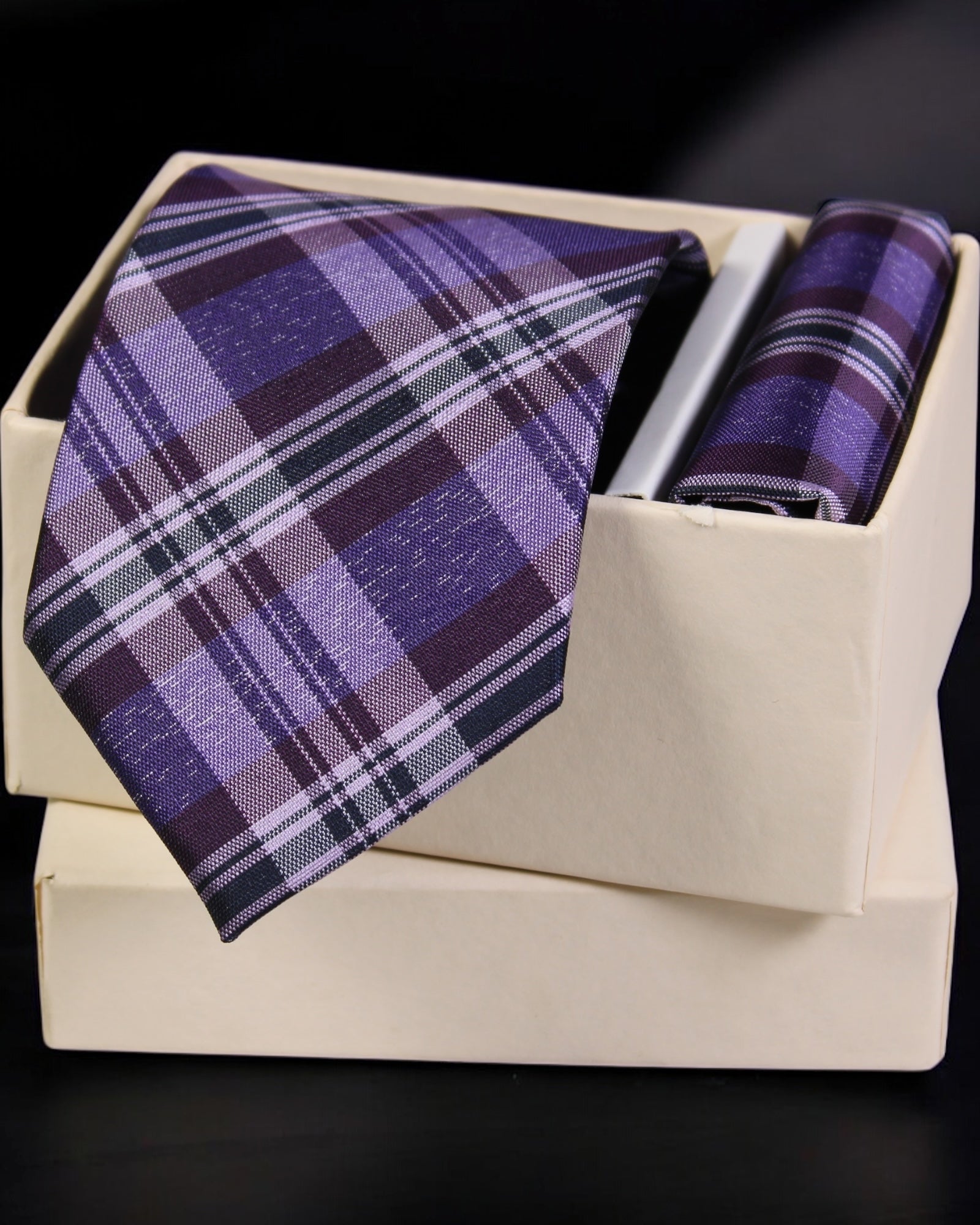 Purple plaid tie and matching pocket square in a beige box on a black background Tie Benon