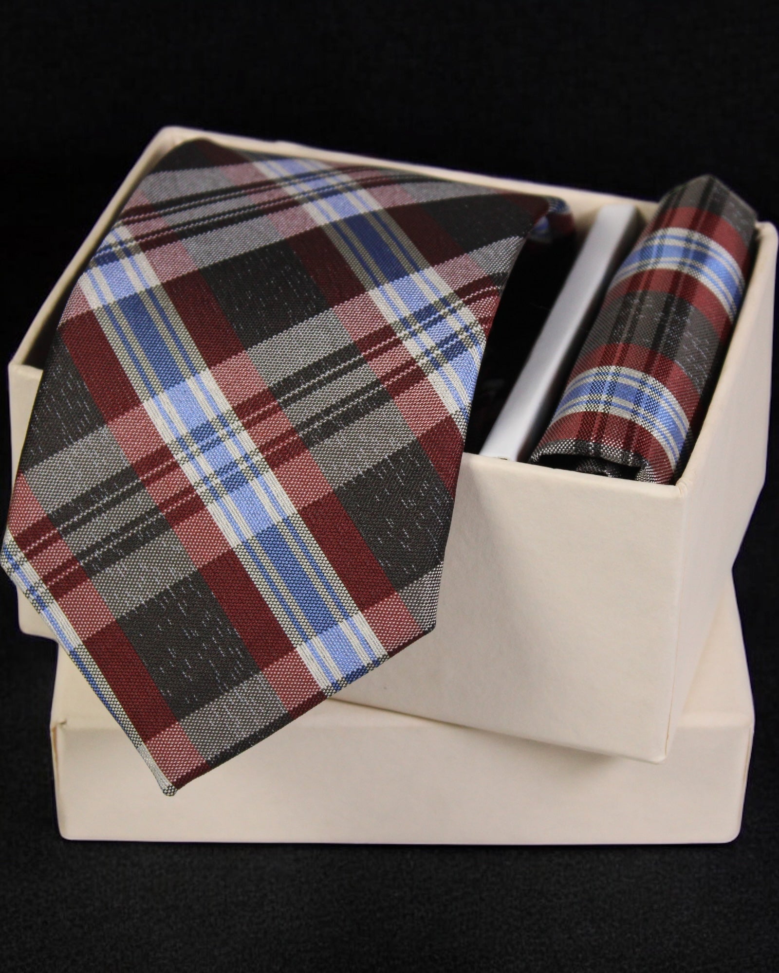 Plaid tie and pocket square set in a white box on a black background Tie Benon