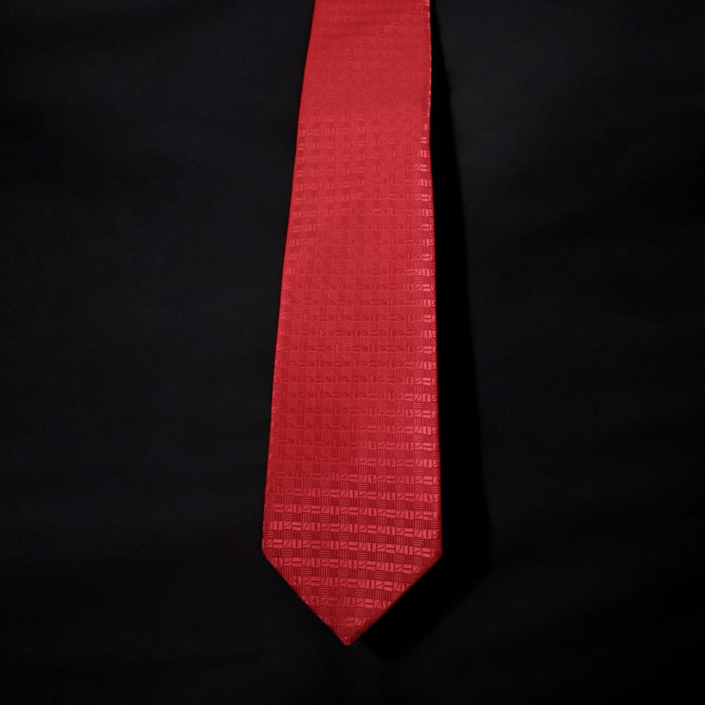 Red tie with a subtle pattern on a black background