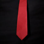 Red tie with a subtle pattern on a black background