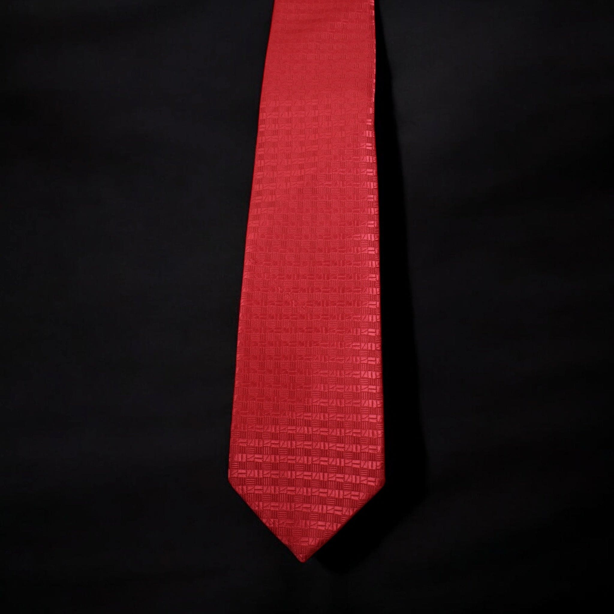 Red tie with a subtle pattern on a black background