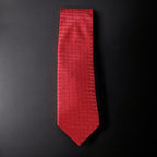 Red textured tie on a black background