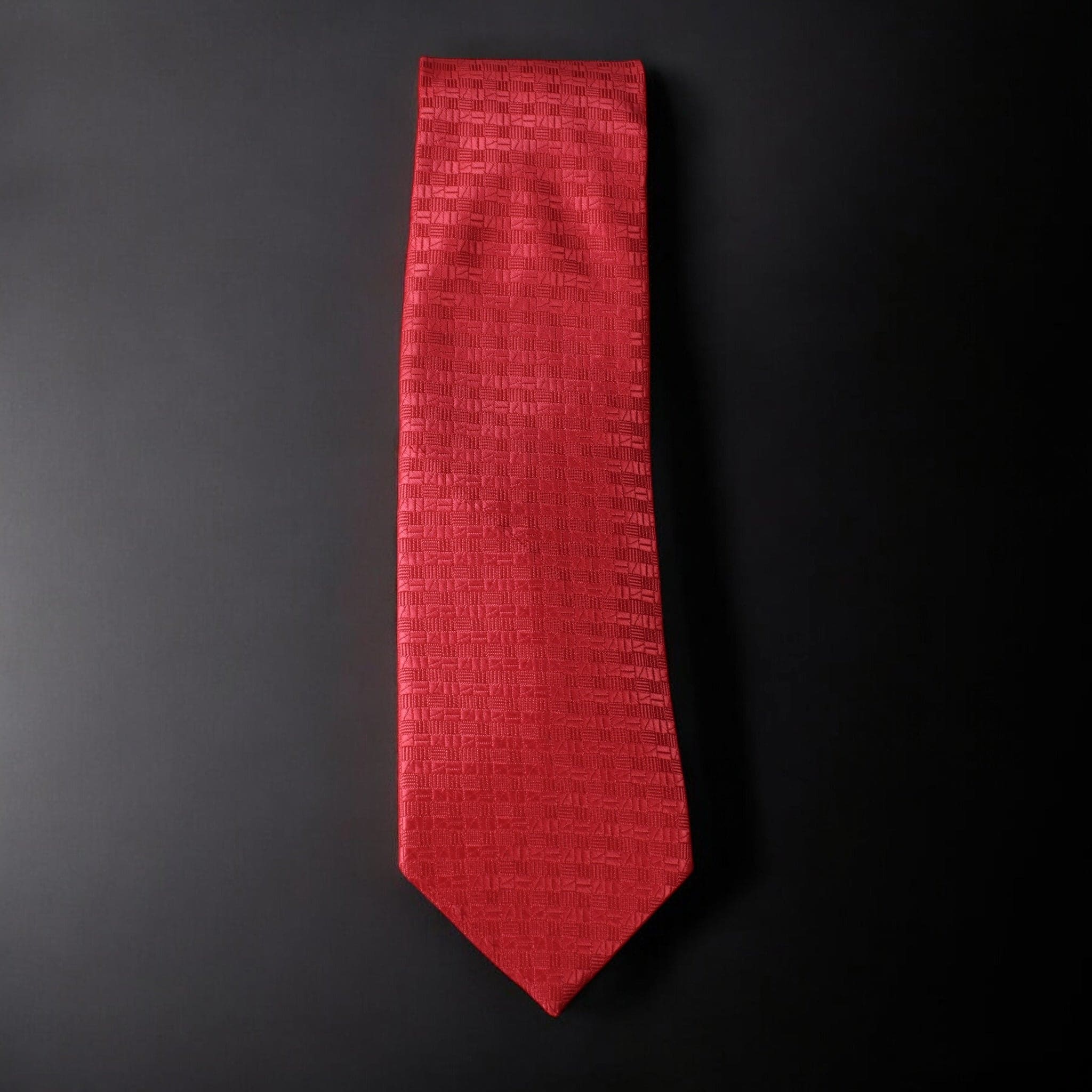 Red textured tie on a black background