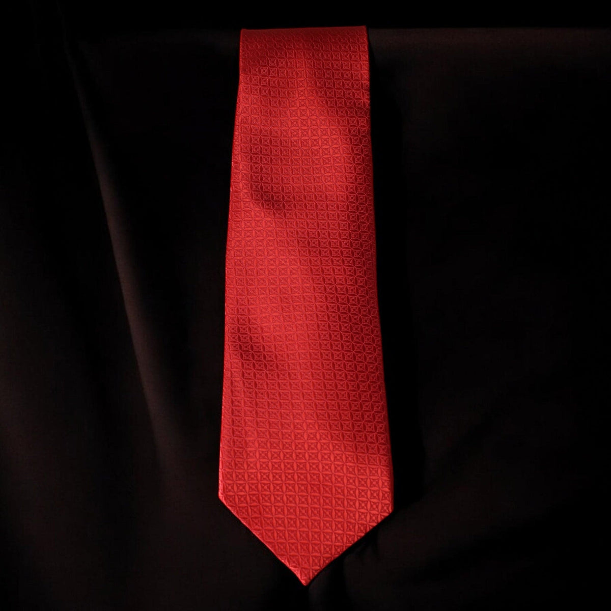 Red patterned tie on a black background