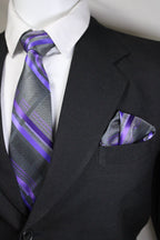 Black suit with a white shirt, purple striped tie, and matching pocket square.