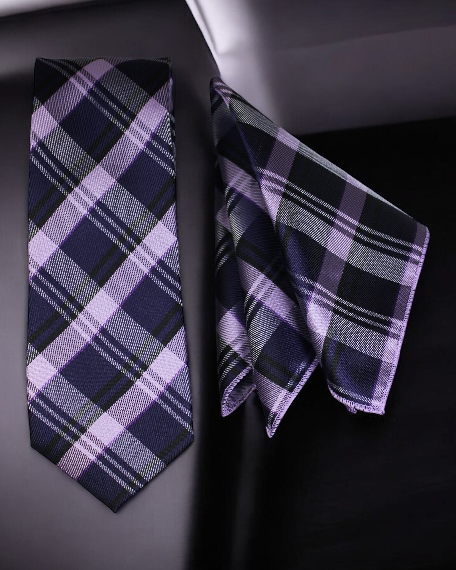 Plaid tie and pocket square set on a dark surface Tie Benon