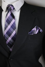 Close-up of a black suit with a purple plaid tie and pocket square Tie Benon