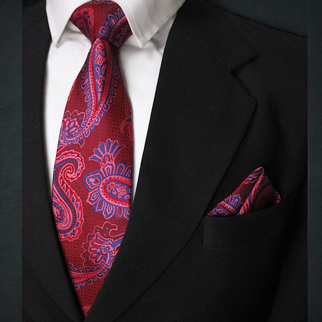 Red paisley tie and matching pocket square on a black suit jacket.