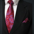 Red paisley tie and matching pocket square on a black suit jacket.
