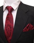 Red paisley tie and matching pocket square on a black suit jacket with white shirt