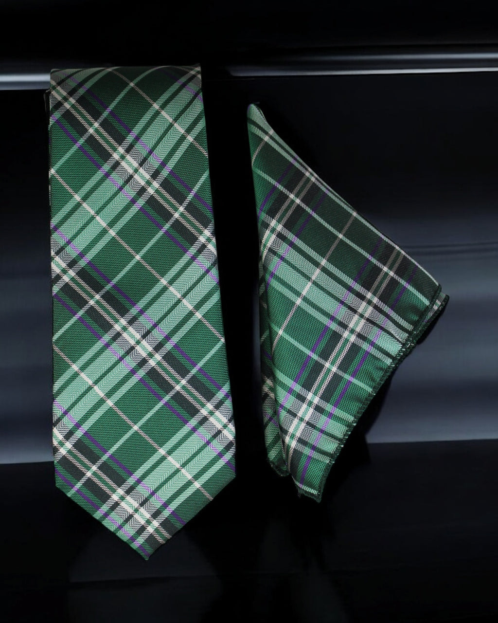 Green plaid tie and pocket square on a dark background
