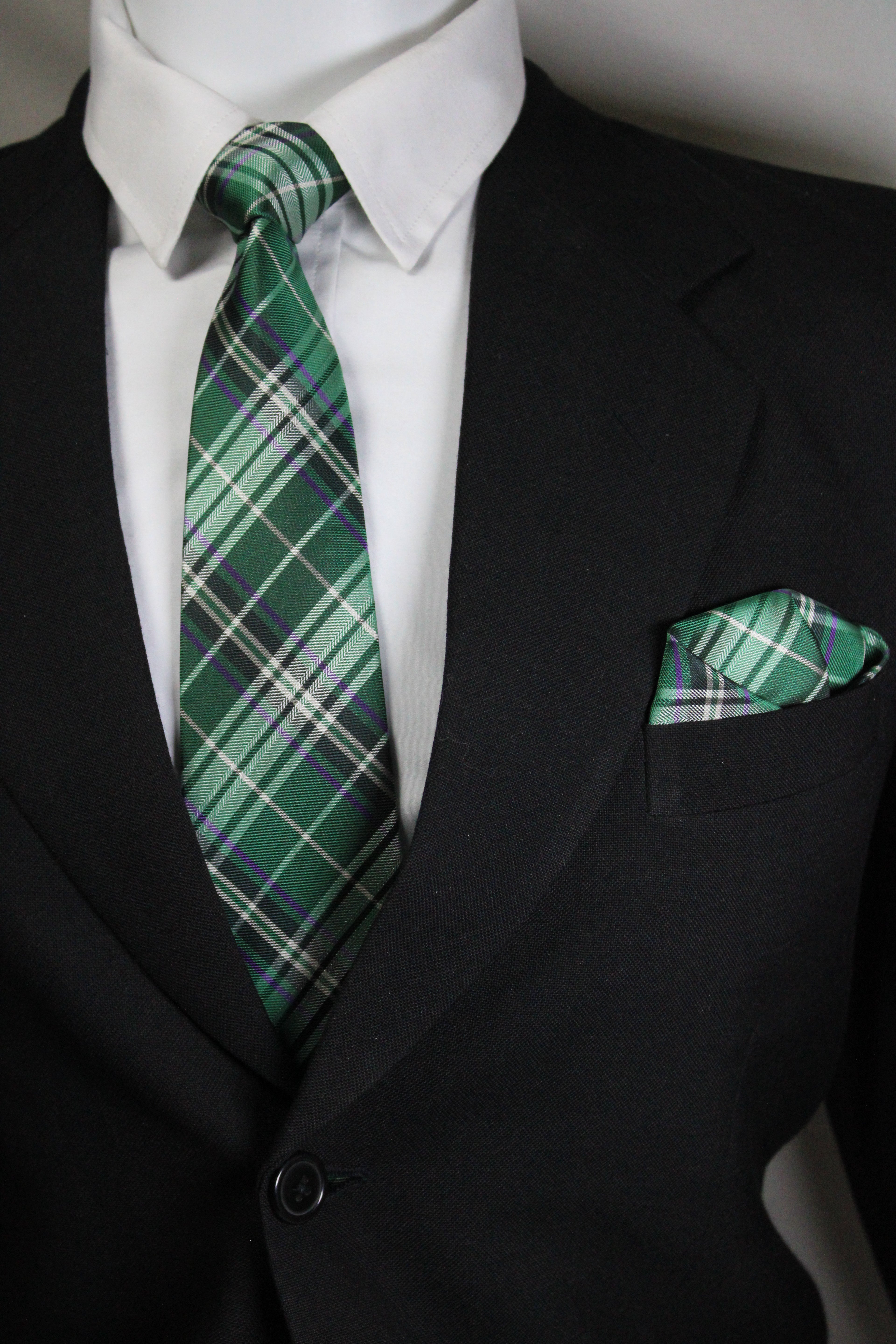 Green plaid tie on a suit with a white shirt