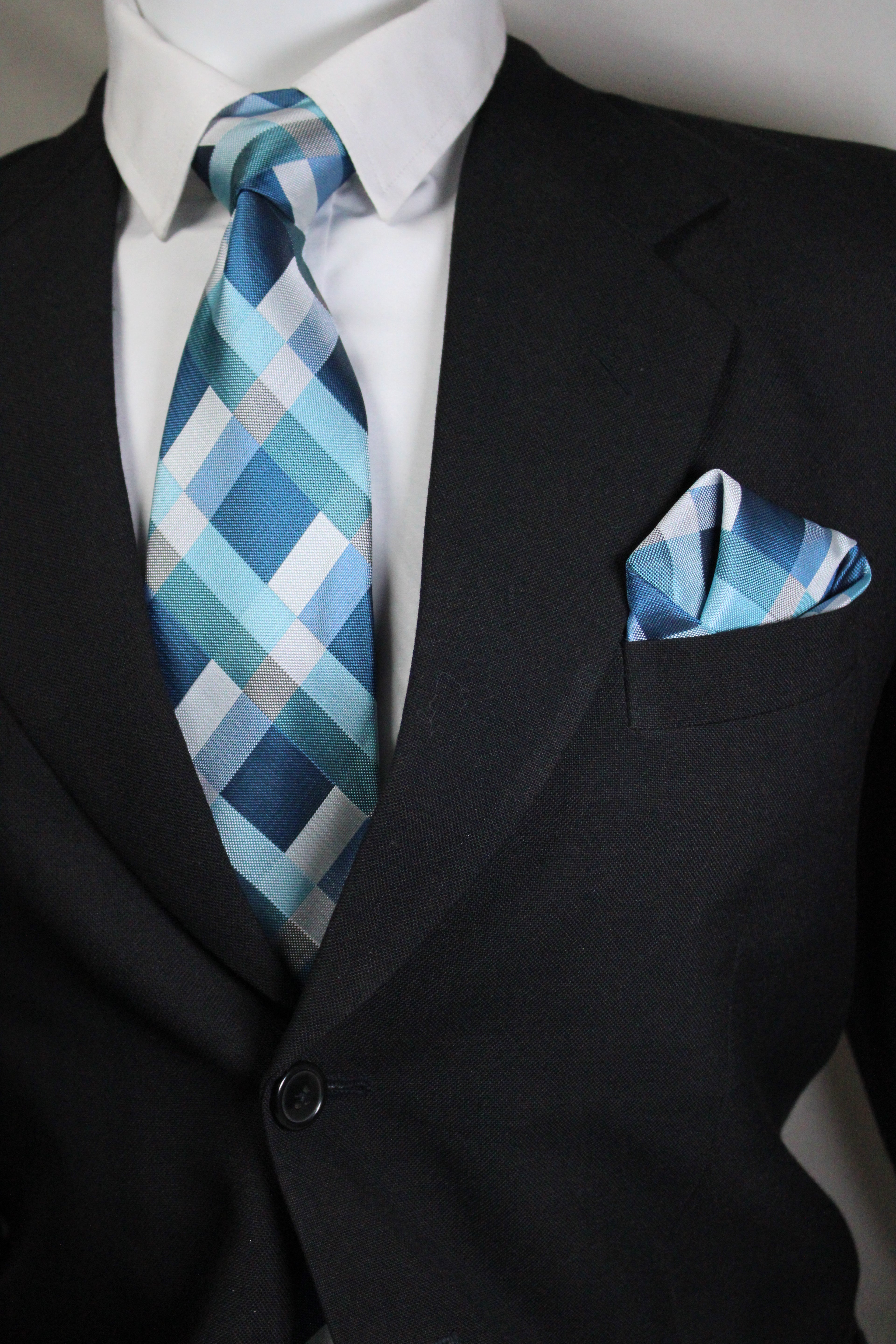 Blue plaid tie and pocket square on a black suit jacket tie Benon
