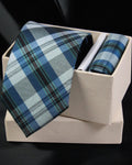 Blue plaid tie and pocket square set in a white box on a black background Tie Benon