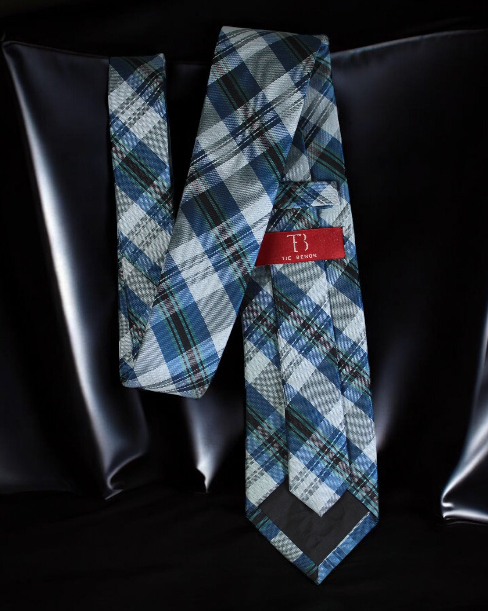 Blue plaid tie with a red label on a black background Tie Benon